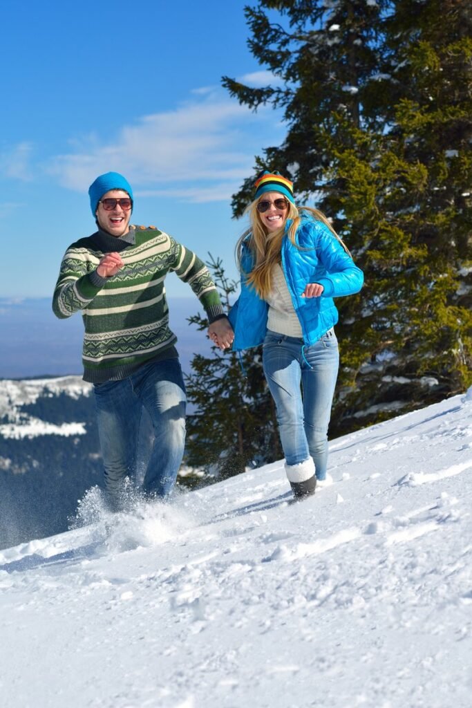Young Couple In winter Snow Scene at  beautiful sunny day